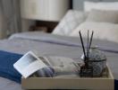 Elegant and serene bedroom detail with aroma diffuser and reading material