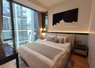 Modern bedroom with large bed and city view