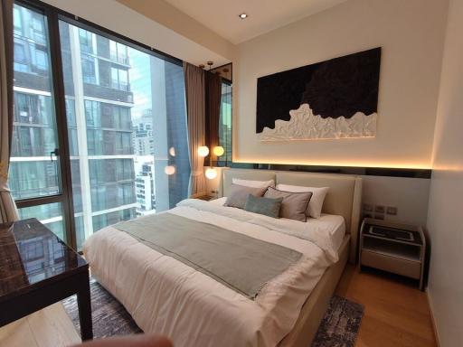 Modern bedroom with large bed and city view