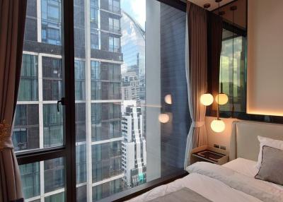 Modern bedroom with a large window and city view