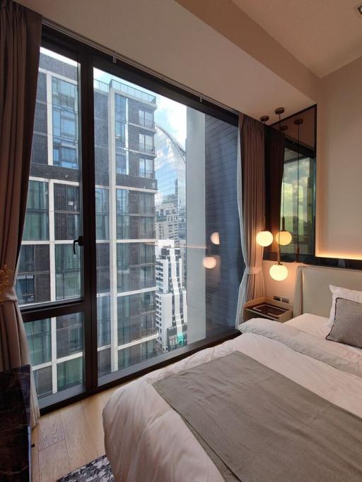 Modern bedroom with a large window and city view