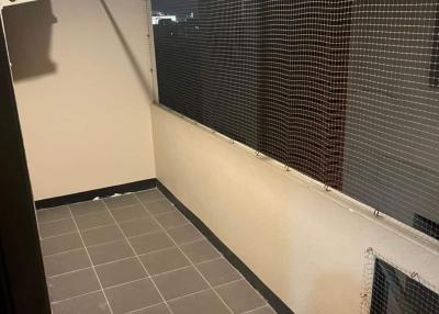 Enclosed balcony with tiled floor and protective mesh screen
