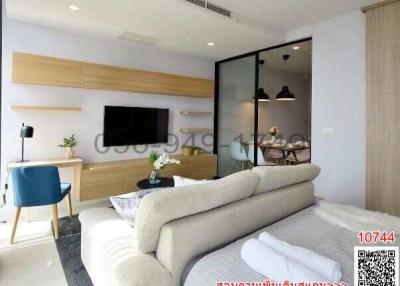 Modern living room interior with couch, TV, and glass partition