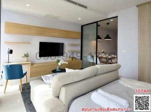 Modern living room interior with couch, TV, and glass partition