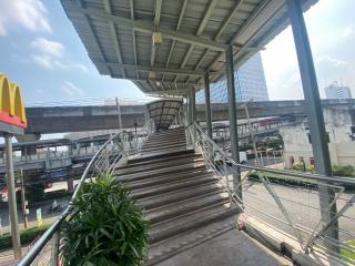 Pedestrian overpass with staircase and railing under a clear sky