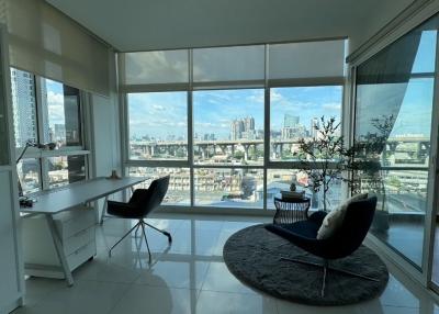 Bright and modern living room with large windows and city view