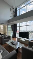 Modern living room with floor-to-ceiling windows and city skyline view