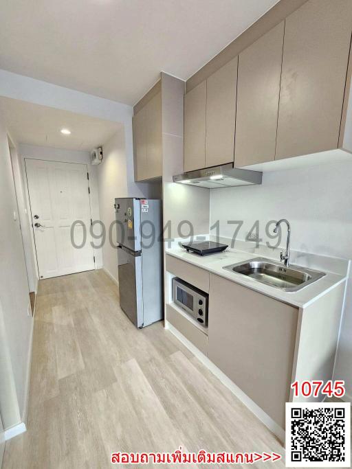 Modern compact kitchen with stainless steel appliances and wooden cabinets