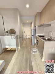 Modern kitchen interior with wooden flooring and well-equipped appliances