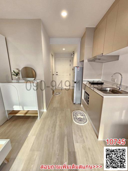Modern kitchen interior with wooden flooring and well-equipped appliances