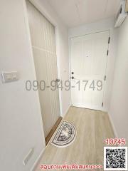 Modern entryway with white doors and wooden flooring