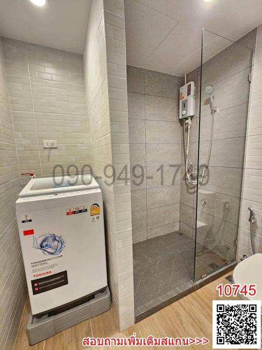 Modern bathroom with shower and washing machine