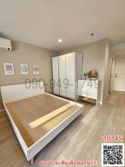 Spacious modern bedroom with laminate flooring and ample natural light