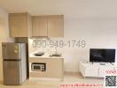 Modern small-scale combined kitchen and living area with appliances and entertainment setup