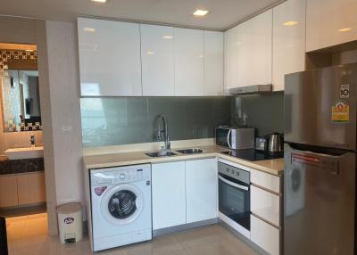 Modern kitchen with stainless steel appliances and washing machine