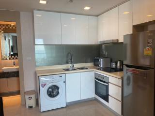 Modern kitchen with stainless steel appliances and washing machine