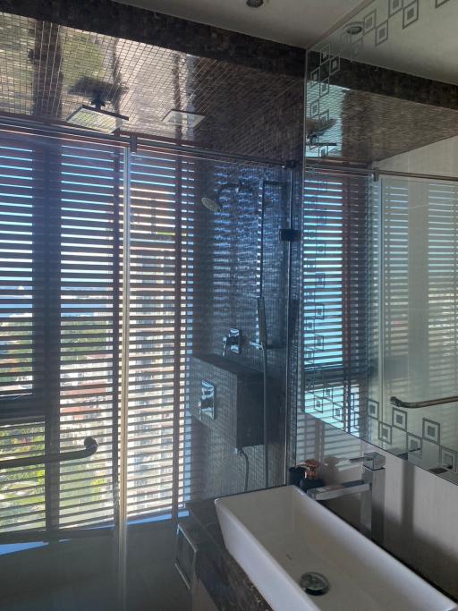 Modern bathroom with natural light and a walk-in shower