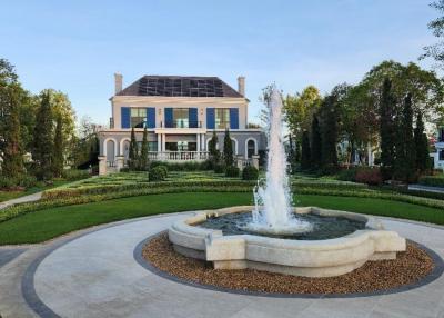Elegant two-story house with landscaped garden and fountain