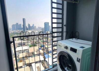 Compact balcony with washing machine and city view