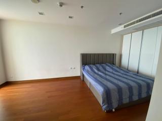 Spacious bedroom with large bed and mirrored closet