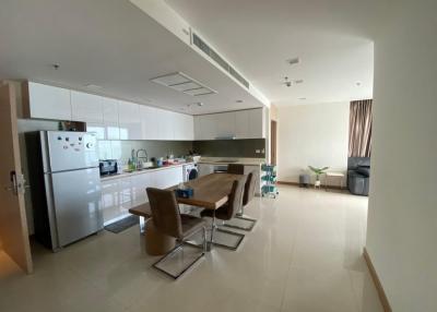 Spacious open-plan kitchen with dining table set and adjacent living space