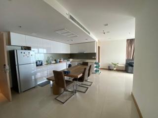 Spacious open-plan kitchen with dining table set and adjacent living space