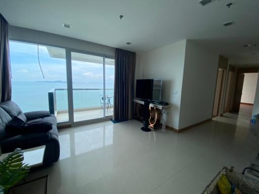 Spacious living room with ocean view and balcony access