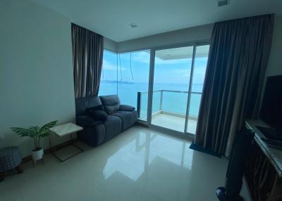 Cozy living room with ocean view and balcony access