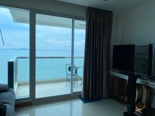 Coastal living room with ocean view and balcony access