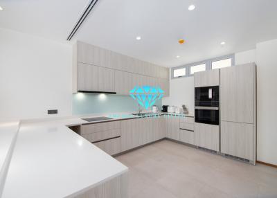 Modern kitchen with white countertops and built-in appliances