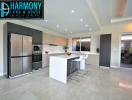 Modern spacious kitchen with stainless steel appliances and breakfast bar