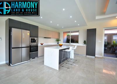 Modern spacious kitchen with stainless steel appliances and breakfast bar