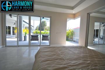 Spacious bedroom with large windows and patio access