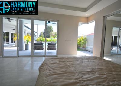 Spacious bedroom with large windows and patio access