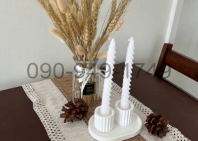 Elegant dining table centerpiece with decorative candles and vase