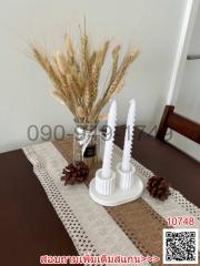 Elegant dining table centerpiece with decorative candles and vase