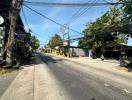 Sunny suburban street view with several shops and parked motorcycles