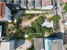 Aerial view of a vacant lot surrounded by residential buildings