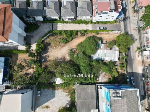 Aerial view of a vacant lot surrounded by residential buildings