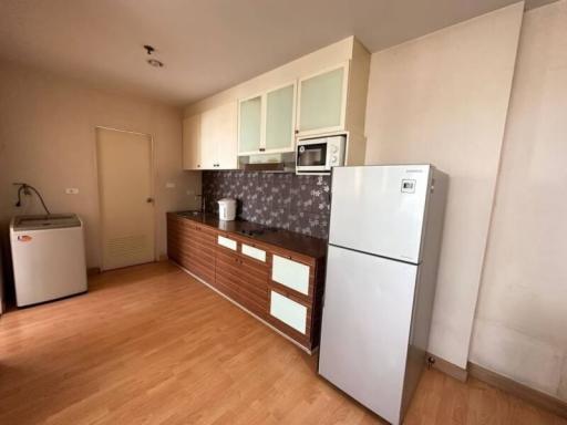 Compact kitchen with modern appliances and wooden flooring