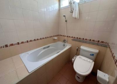 Spacious bathroom with bathtub and toilet
