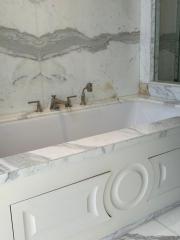 Elegant marble bathroom with a large bathtub and luxurious fixtures
