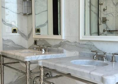 Elegant bathroom with marble details and glass shower enclosure