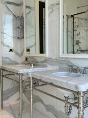 Elegant bathroom with marble details and glass shower enclosure