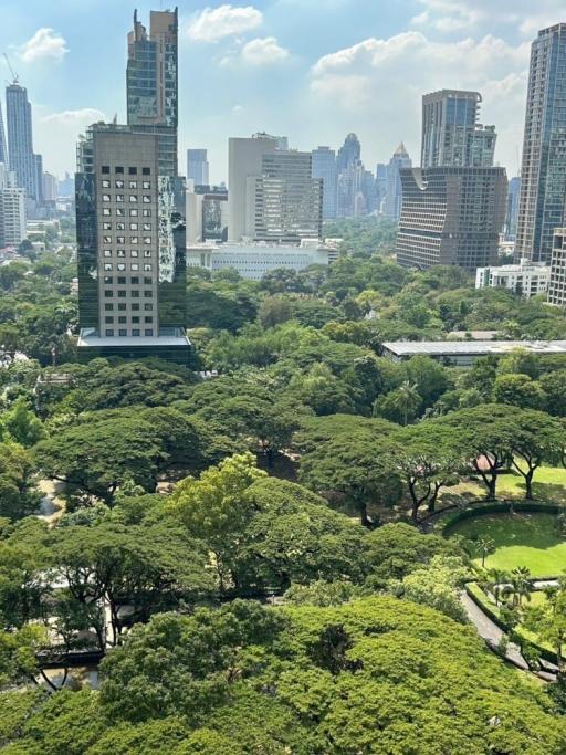 Aerial view of a cityscape with lush greenery from a high-rise building