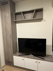 Modern living room interior with mounted television and shelving