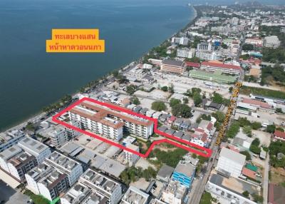 Aerial view of a coastal real estate property outlined in red