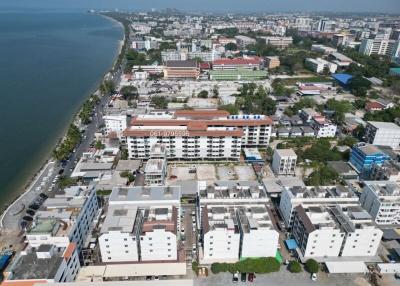 Aerial view of a coastal residential district with apartment buildings and nearby beach