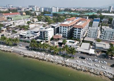 Aerial view of a coastal residential neighborhood with buildings and street