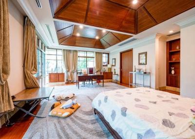 Spacious bedroom with elegant wooden ceiling and ample natural light
